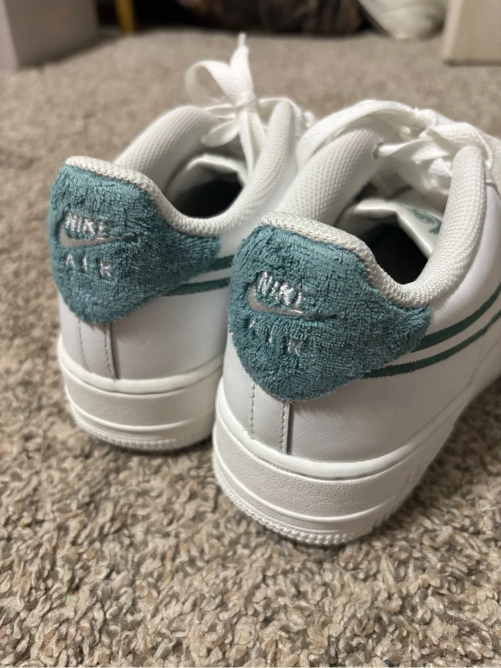 Nike Air Force 1 shoes with green accents